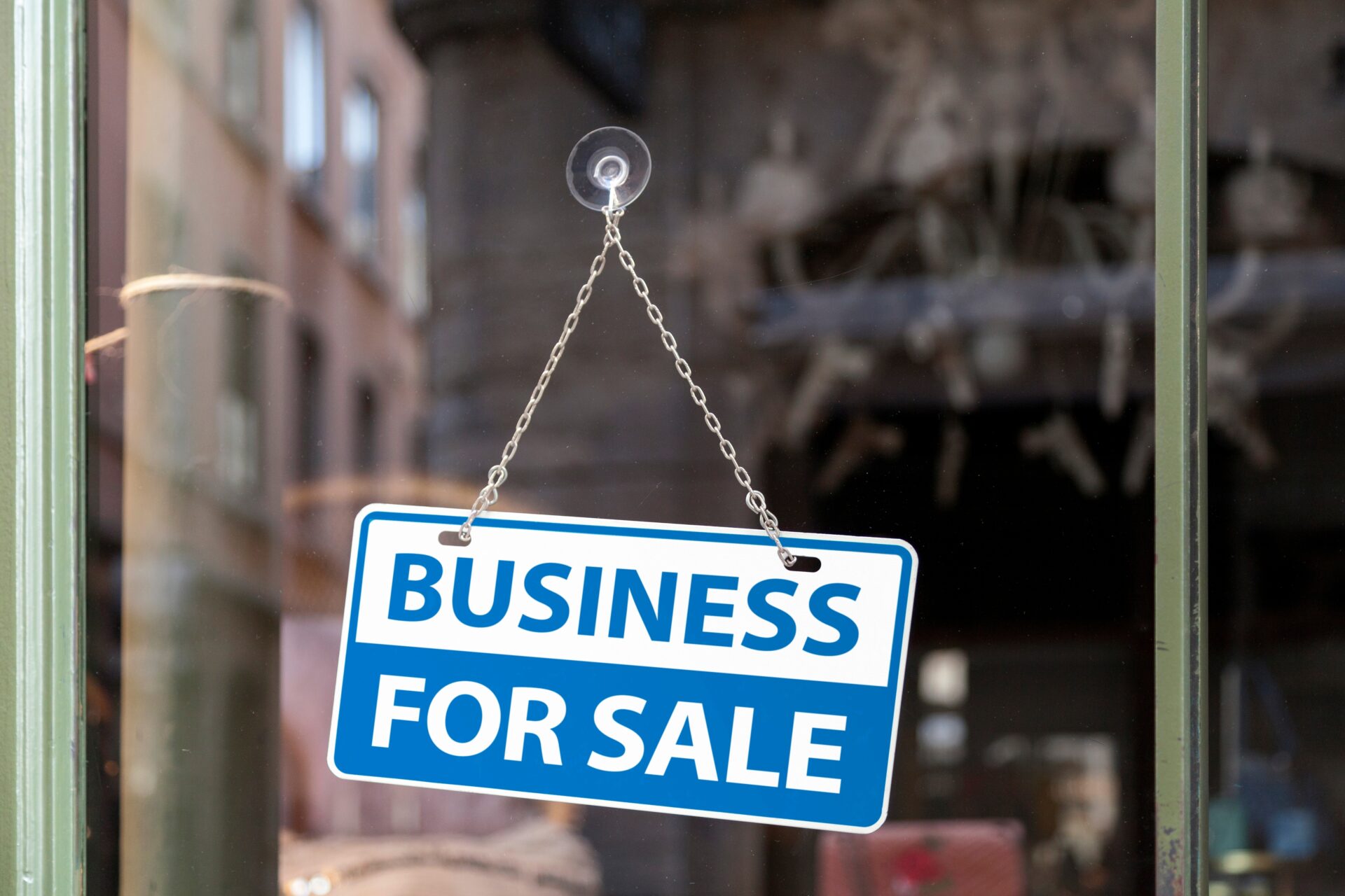 Business For Sale sign in a shop window